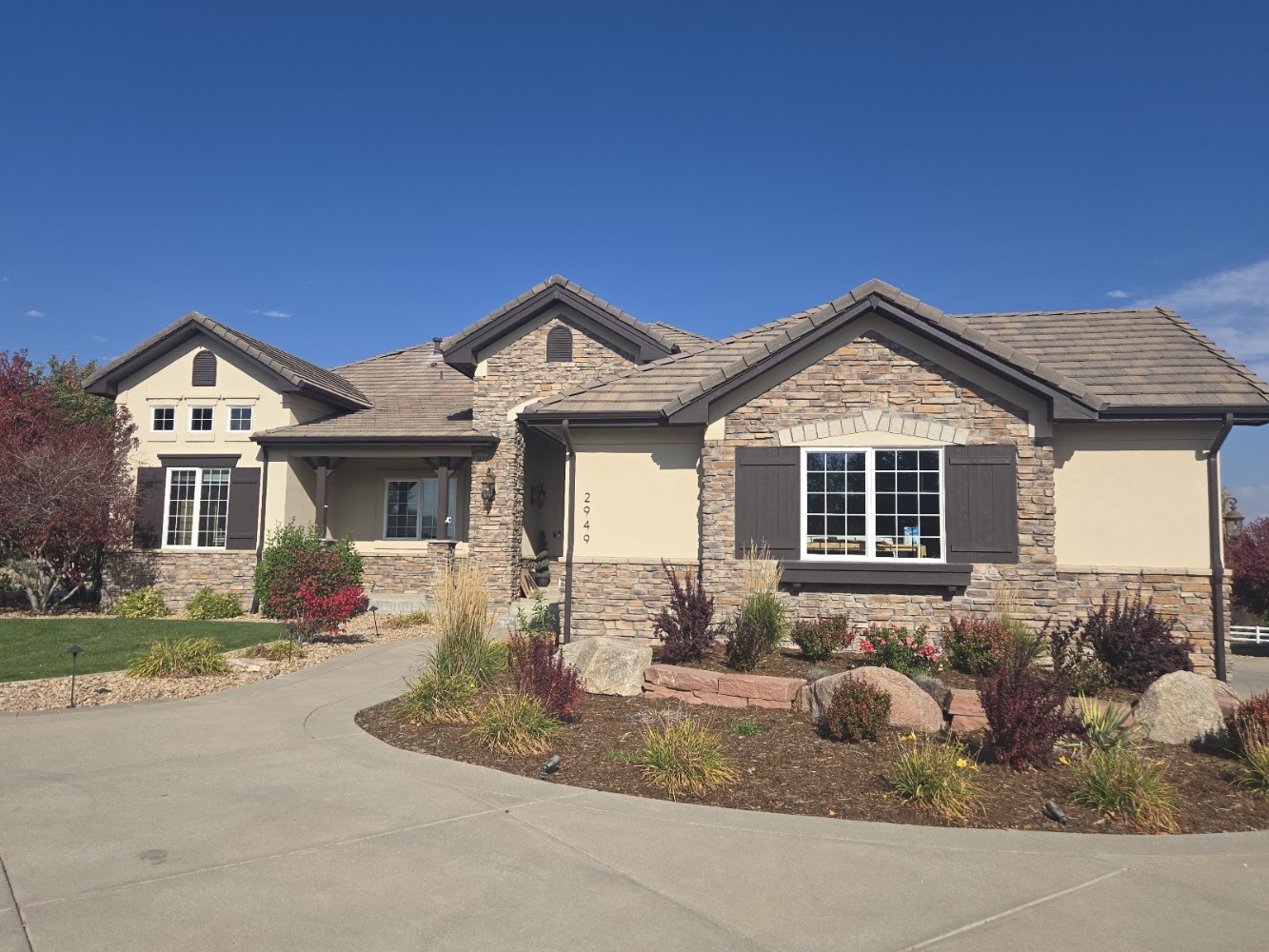 Completed stone-front home roof in Douglas County